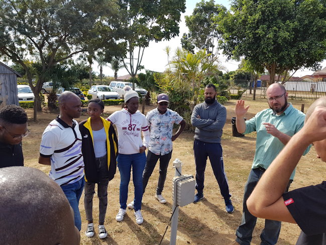 Gregor Feig showing the setup of a weather station at the Vuwani site Gregor Feig showing the setup of a weather station at the Vuwani site